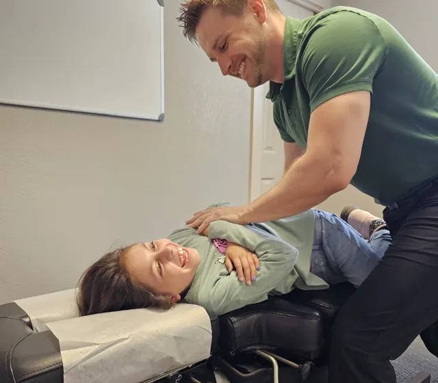 Dr. Brett Chavez treating a patient at Back 2 Health Chiropractic